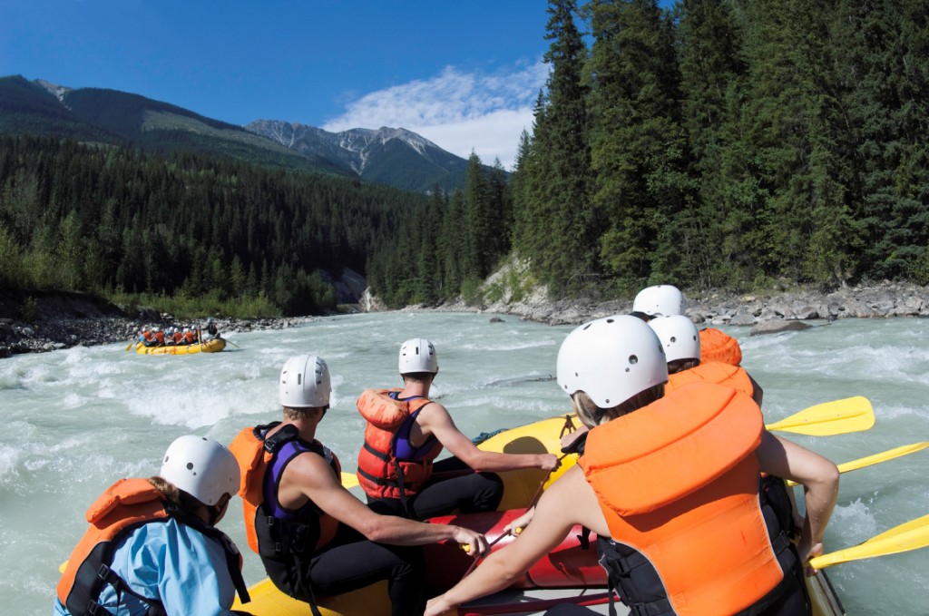 Groups of adventurers enjoy some white water rafting.