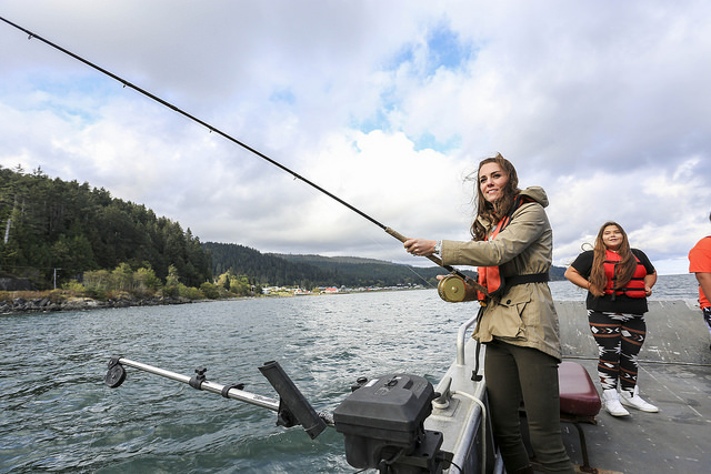 Kate Middleton, Duchess of Cambridge, fishing under a cloudy sky.