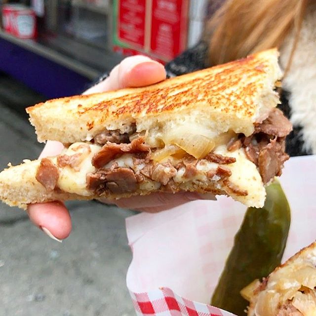 A delectable grilled cheese sandwich made with onions and pulled pork.