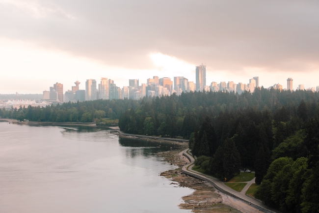 The Stanley Park seawall hugs the coastline with the Vancouver skyline in the background.