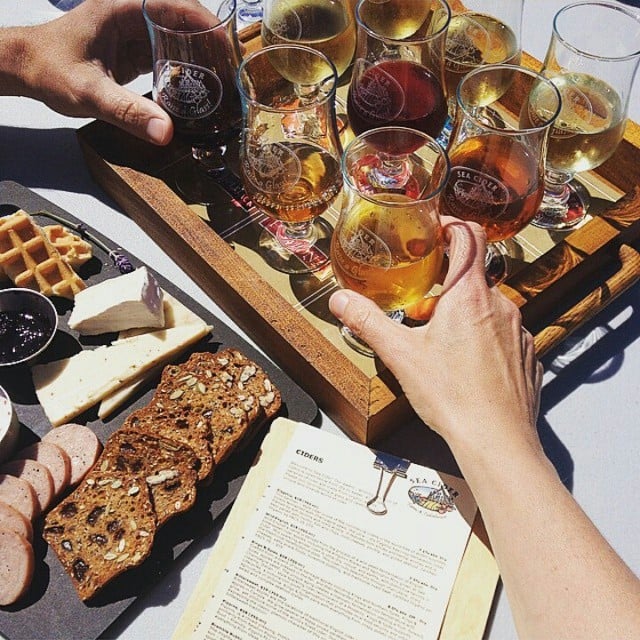 A tray of cider samples and a charcuterie plate.