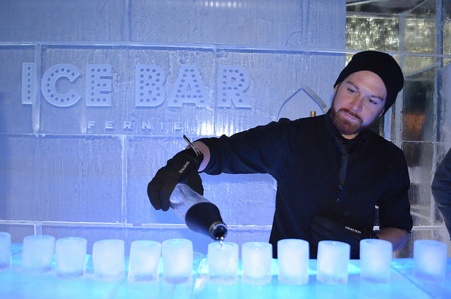 A bartender pours shots into ice shot glasses at the Fernie Ice Bar.