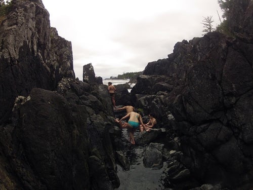 People climbing into the soaking pools at Hot Springs Cove in Tofino, BC.