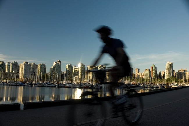 Silhouette of a cyclist against the Vancouver skyline.