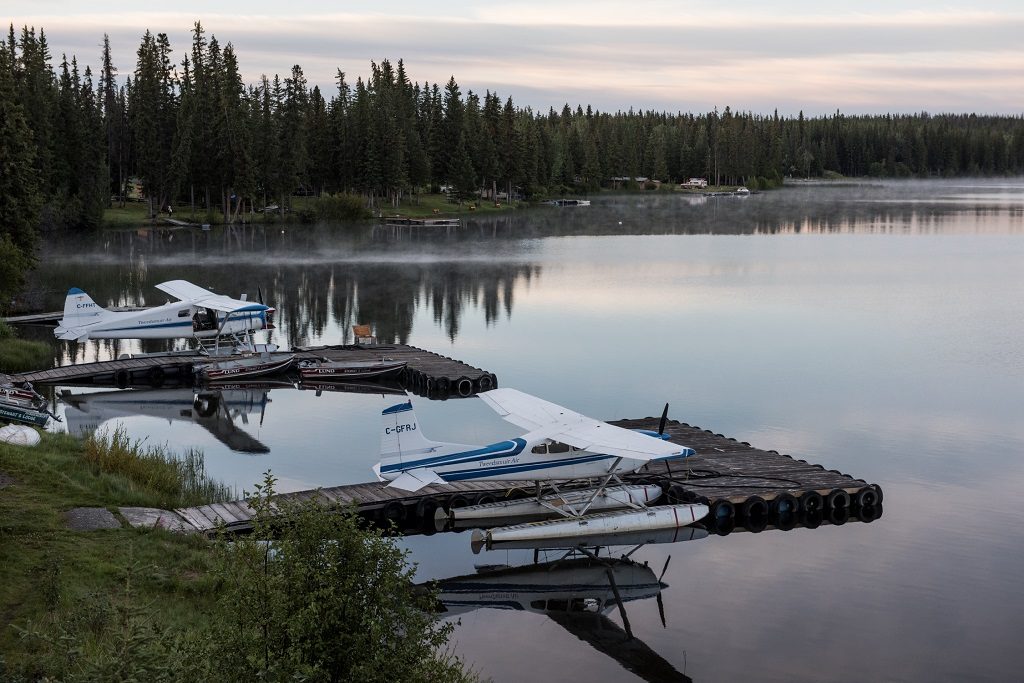 Two seaplanes docked at two floating docks.