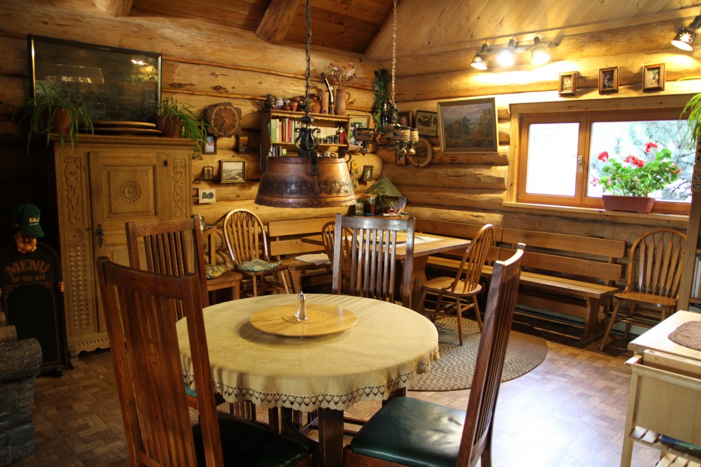 Interior of a log cabin’s cozy dining room.