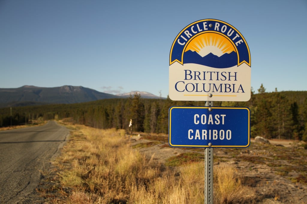 A sign next to a highway that reads British Columbia Circle Route Coast Cariboo”.