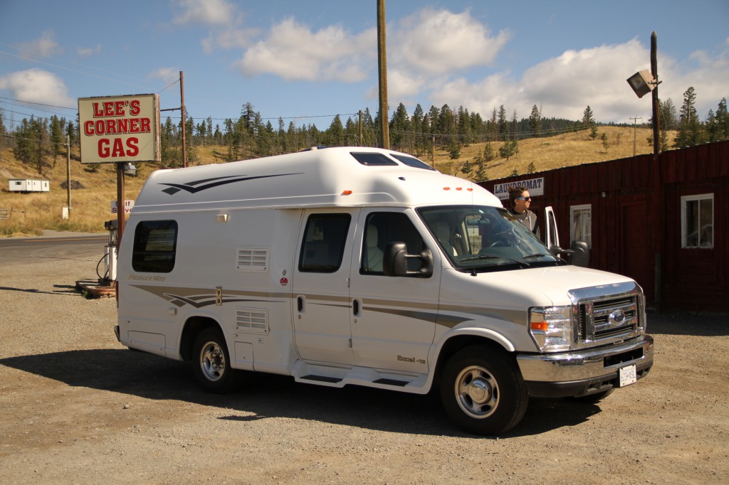 An RV is parked in front of a sign that reads “Lee’s Corner Gas”.