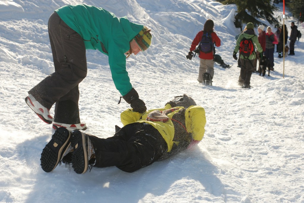 A man sliding down a trail on his stomach