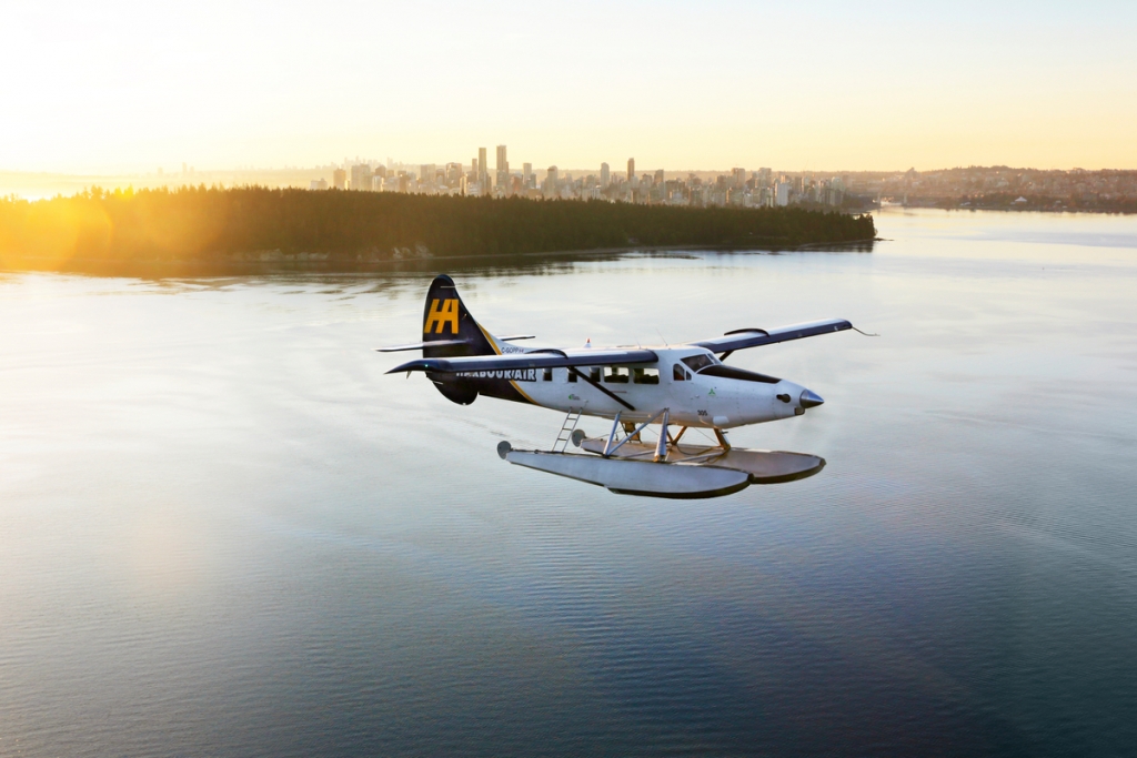 Harbour Air seaplane with Vancouver in the background | Harbour Air