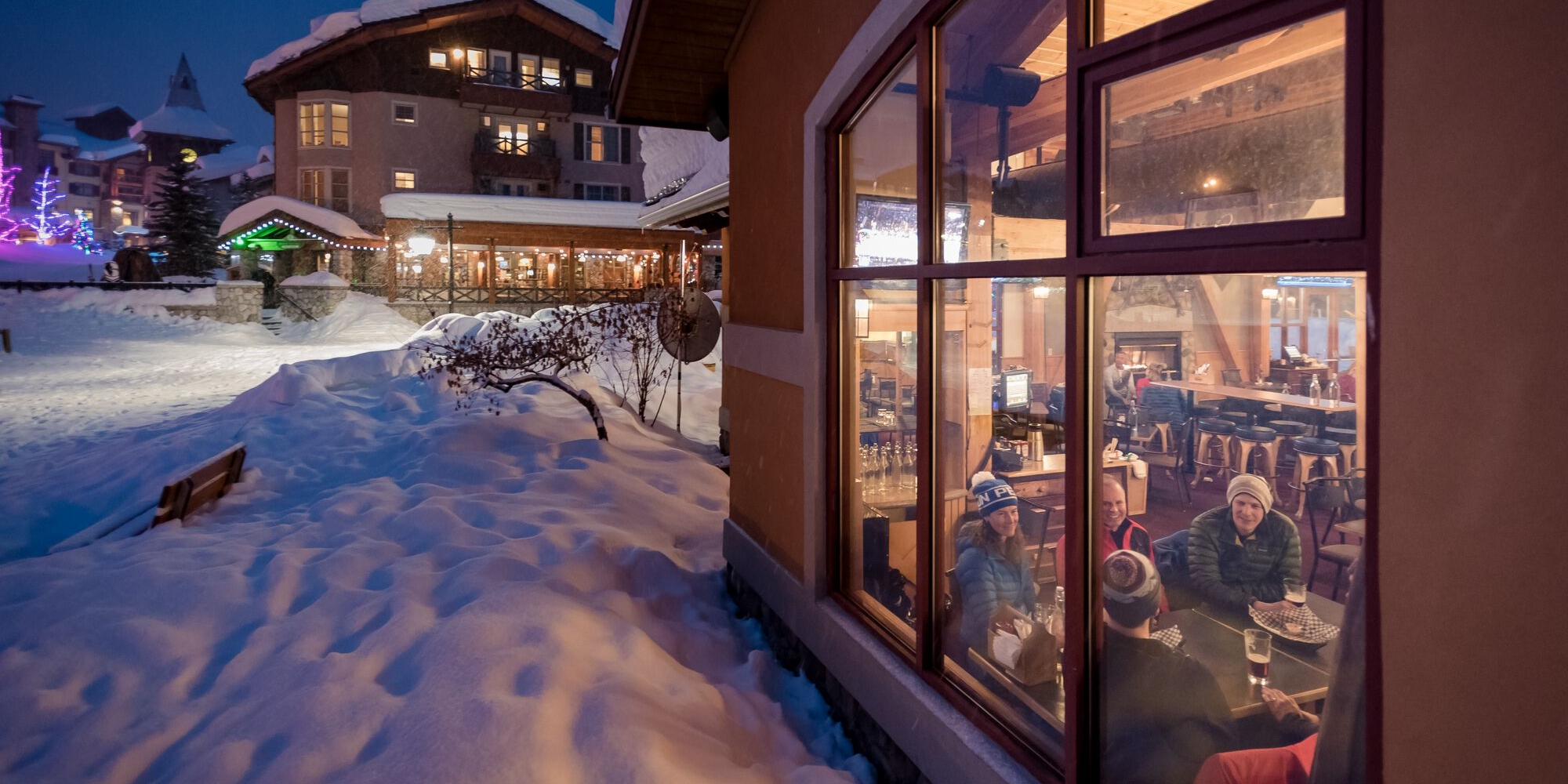 A group enjoys a post-ski meal in the village at Sun Peaks Resort | Reuben Krabbe