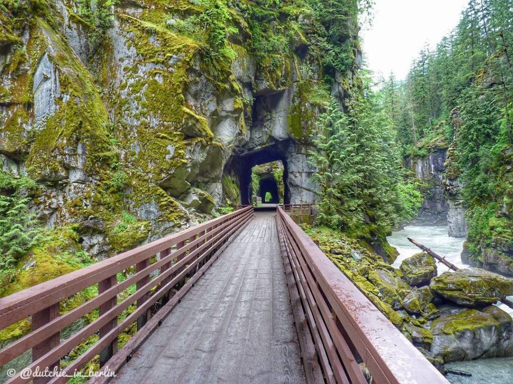 Lush green surrounds the Othello Tunnels on the Kettle Valley Rail Trail. 
