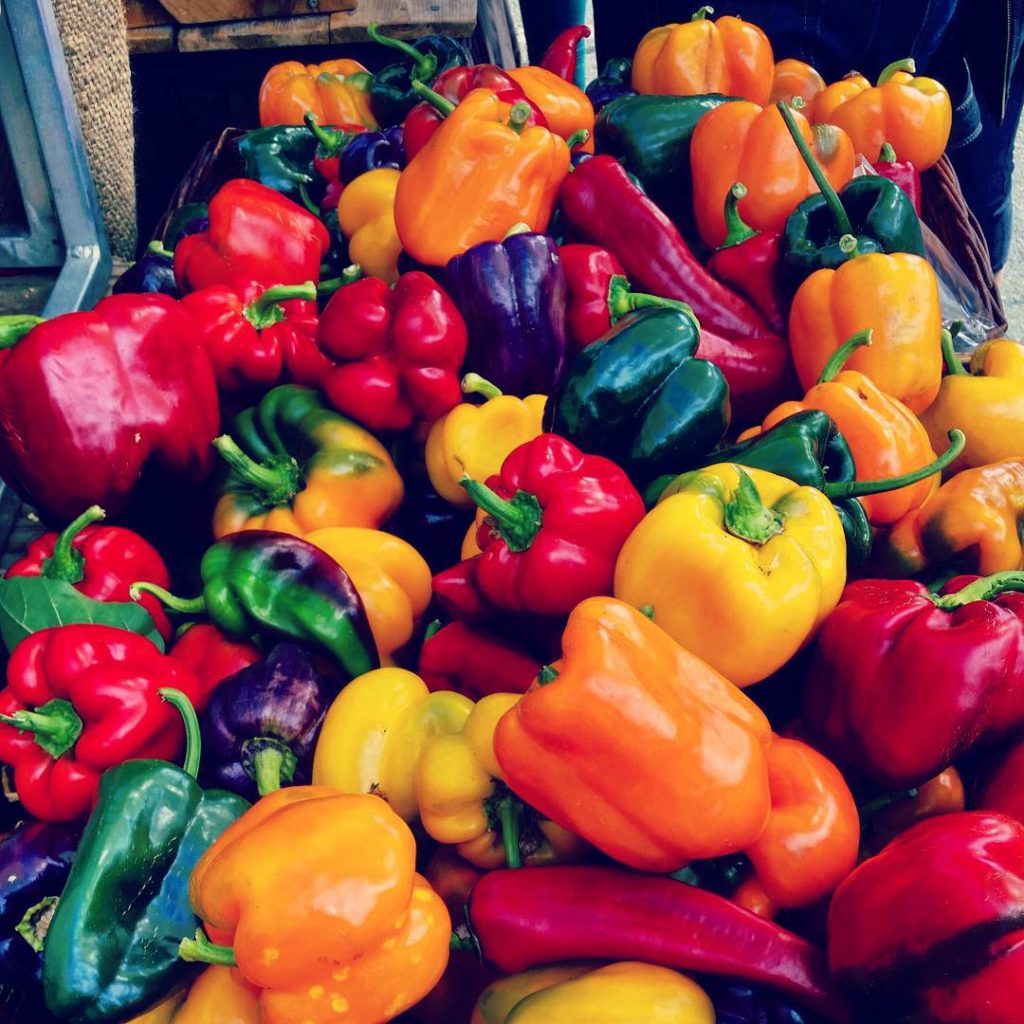 A table full of colourful bell peppers.