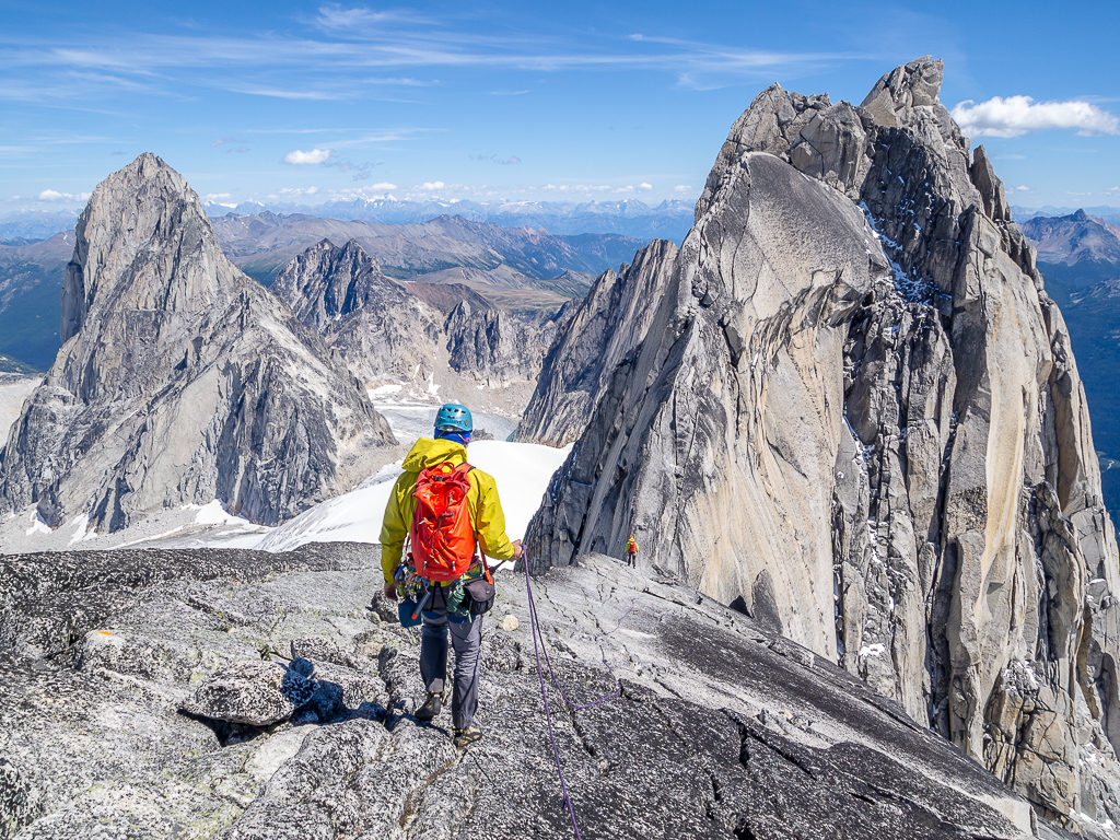 A hiker traverses a rocky, mountainous landscape.