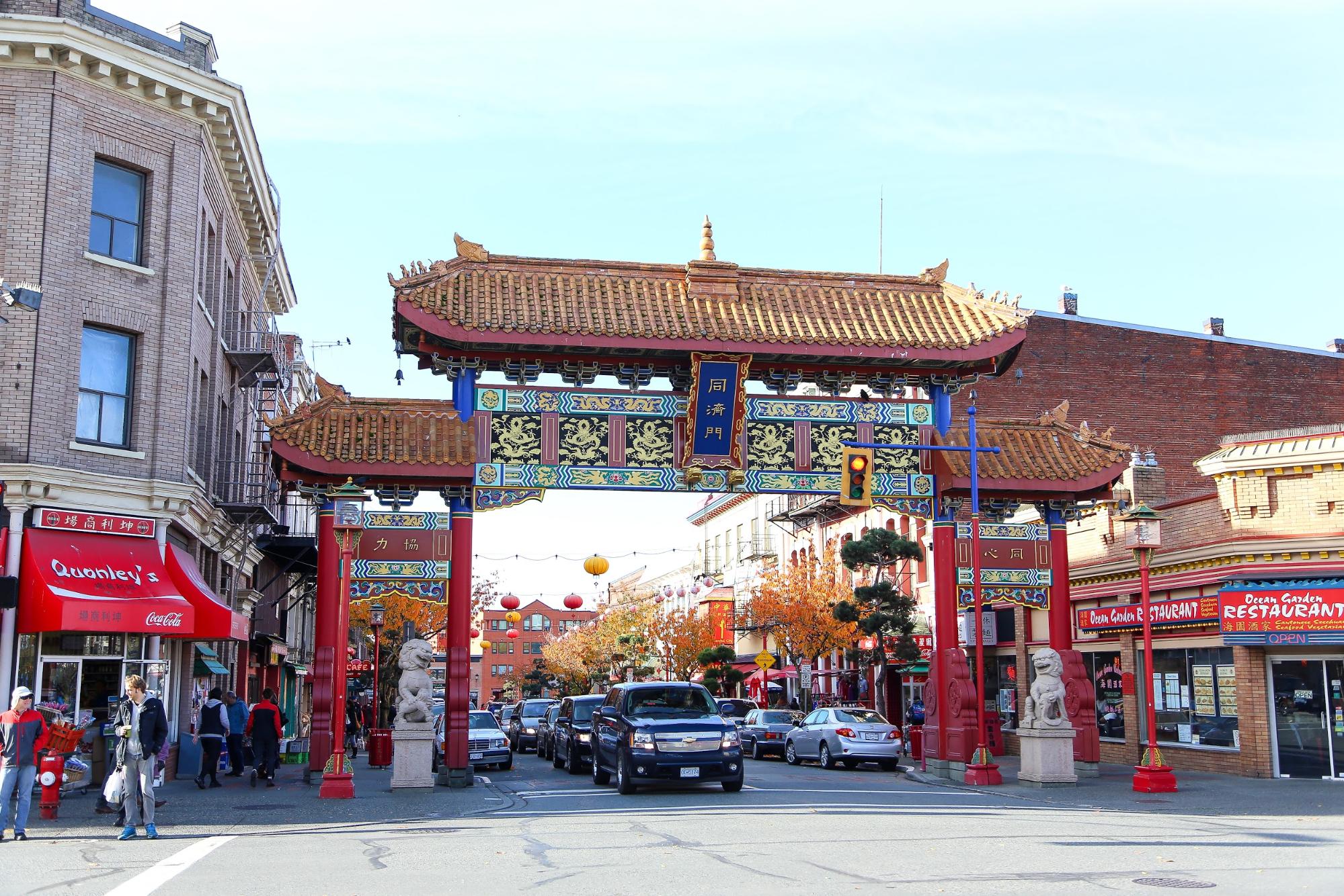 An intricately designed entrance on a city street to Chinatown in Victoria, BC.