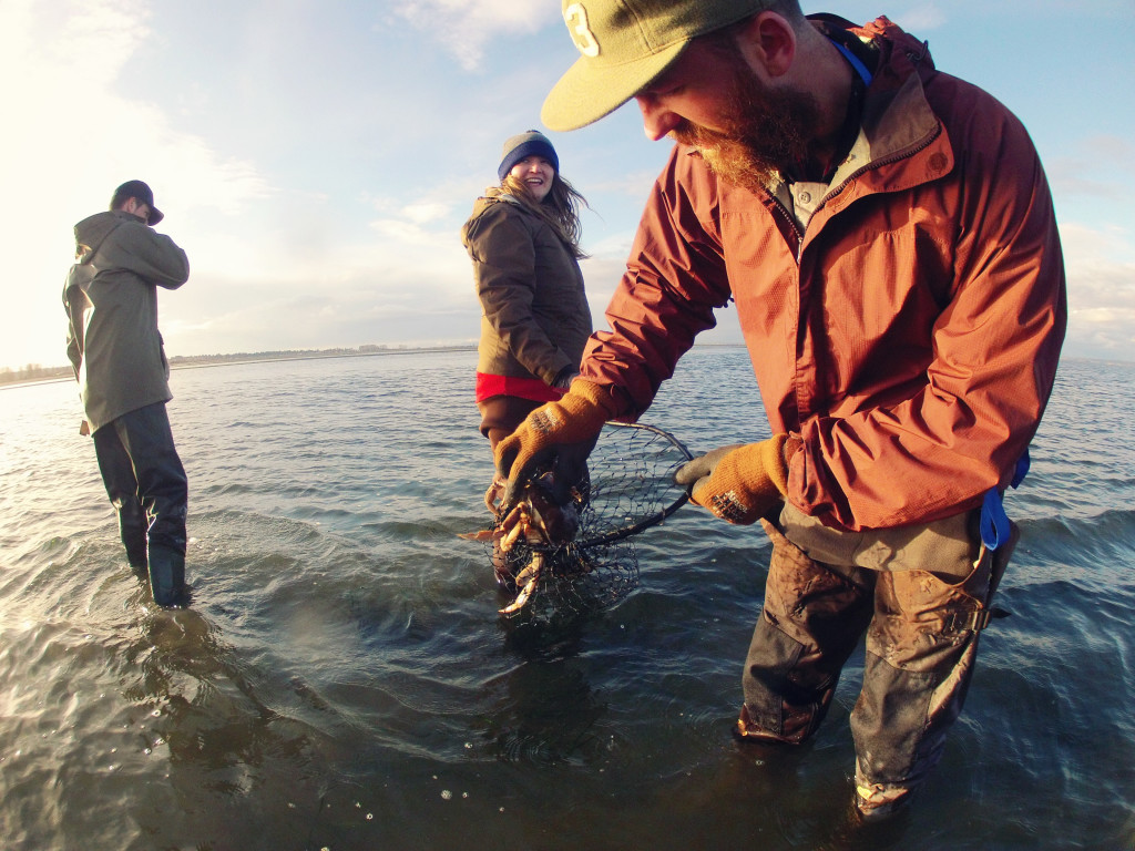 A crab fisherman releases a crab back into the ocean.