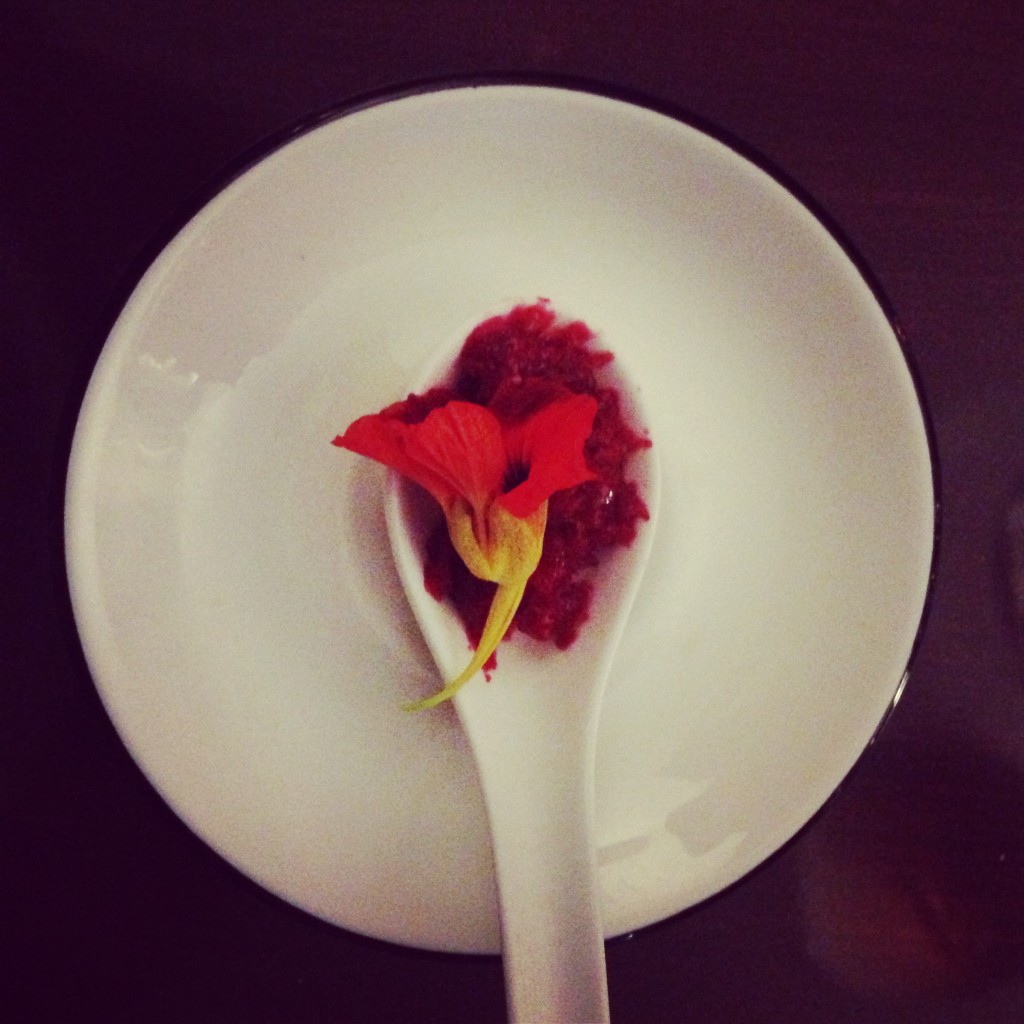 An artfully plated palate cleanser on a white spoon.
