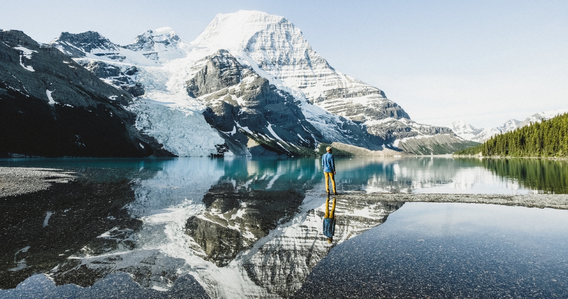 A person stands by a lake in Mount Robson Provincial Park