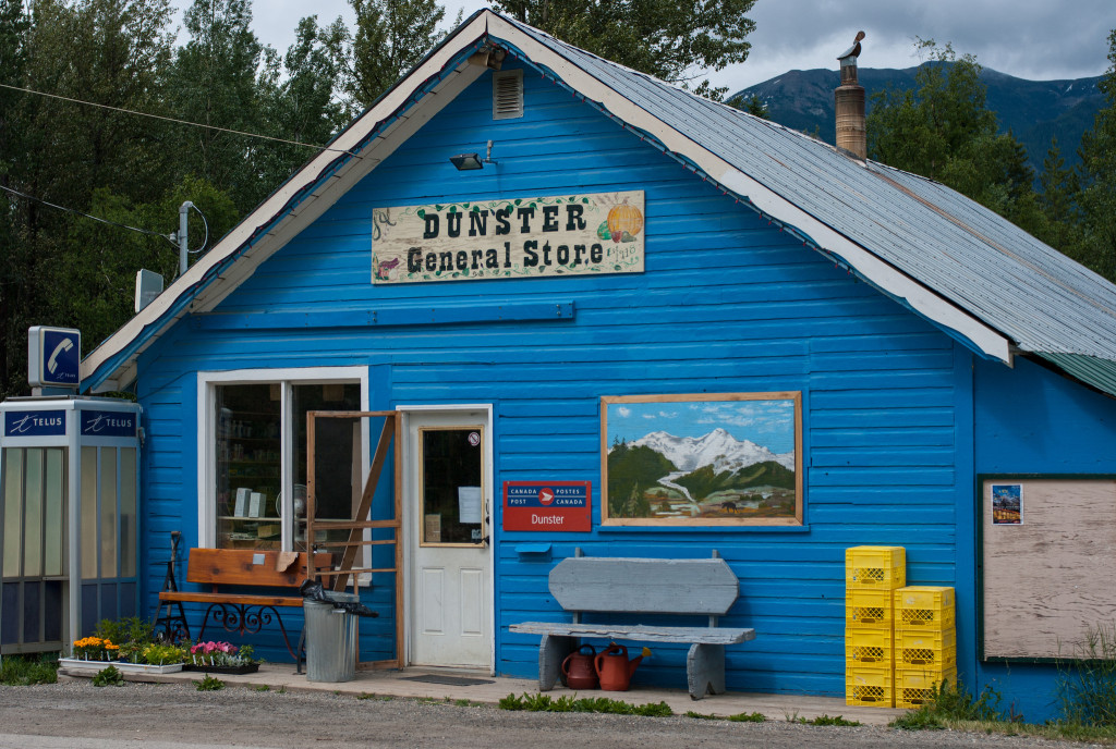 A bright blue store front with a sign that says Dunster General Store.