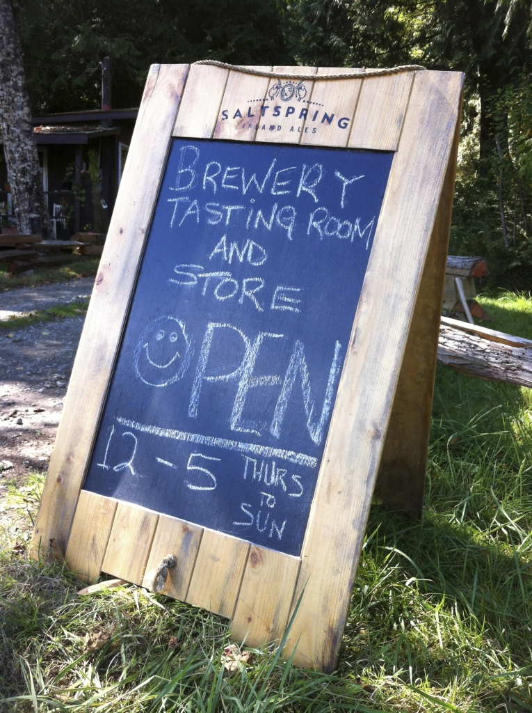 A sign advertising Salt Spring Island Ale' tasting room and store.