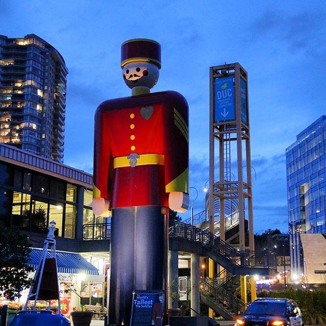 The world’s tallest tin soldier stands in the middle of a busy downtown area.