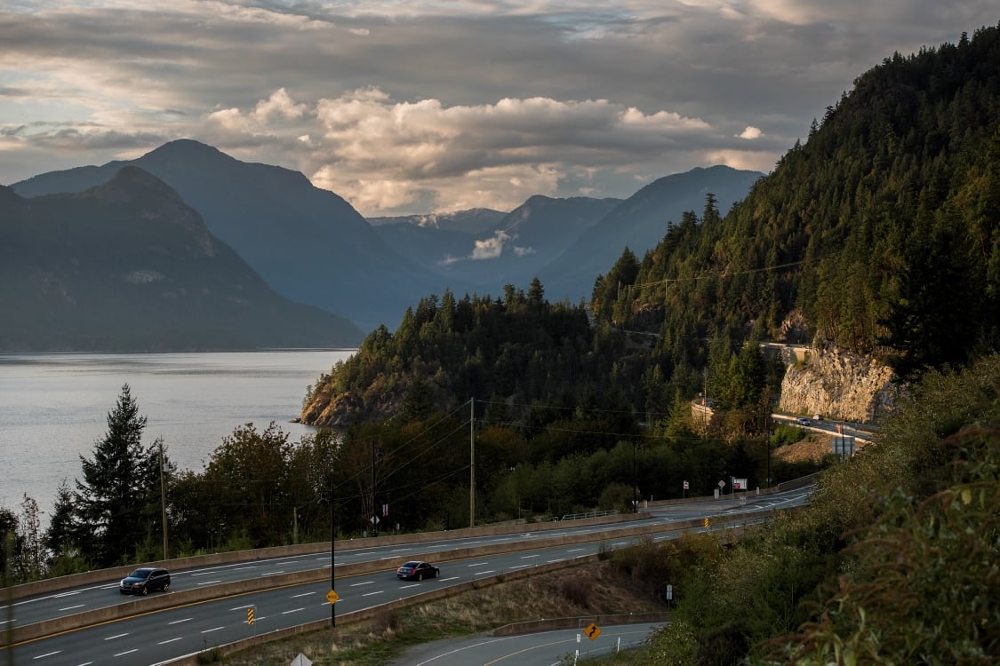 A highway leading along the coast into mountains.