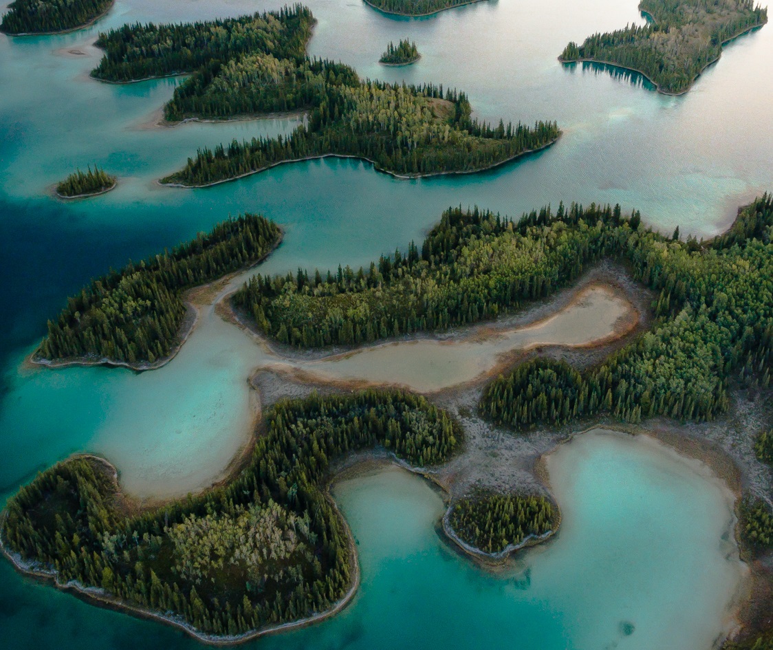Aerial photo of small tree islands in Boya Lake in Tā Ch’ilā Provincial Park, Northern BC