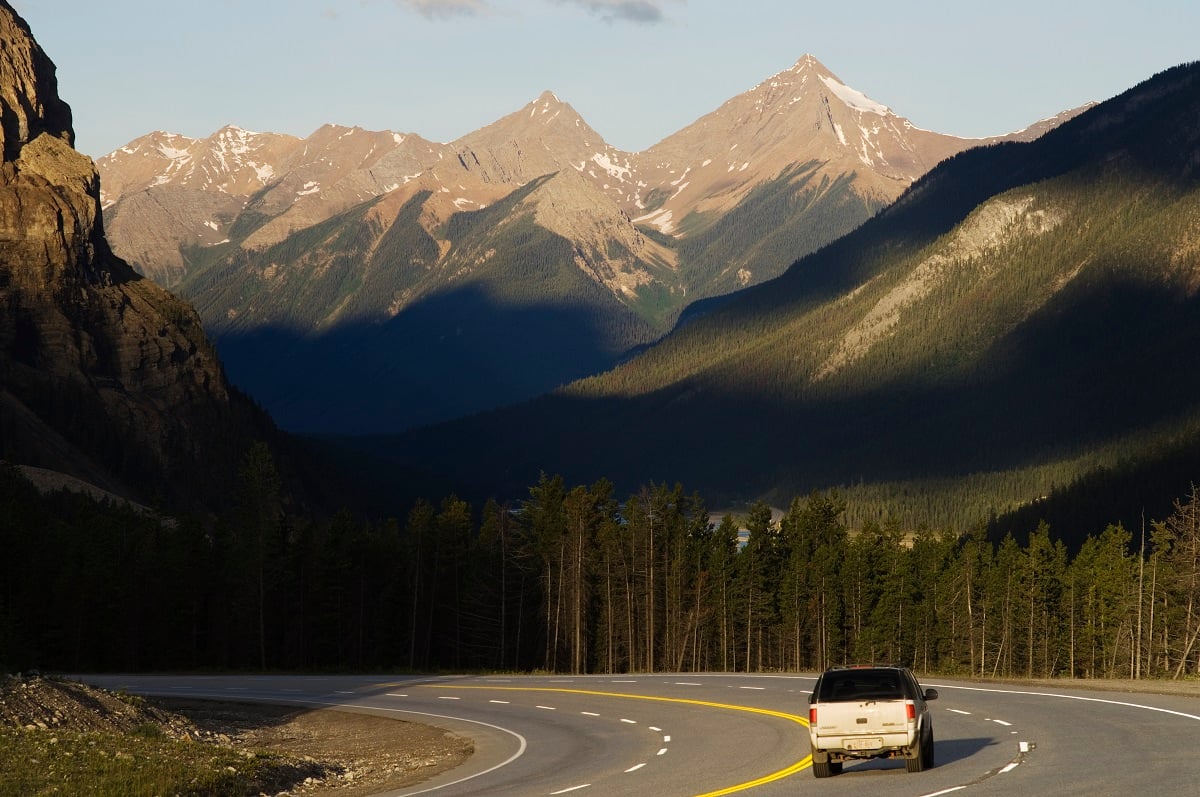 A car drives down the road in Yoho National Park