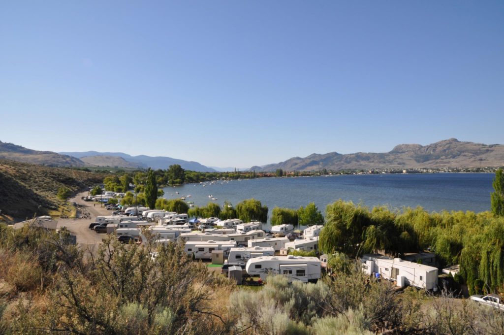 RV's are parked along the shore of Osoyoos Lake at Nk’Mip RV Park and Campground