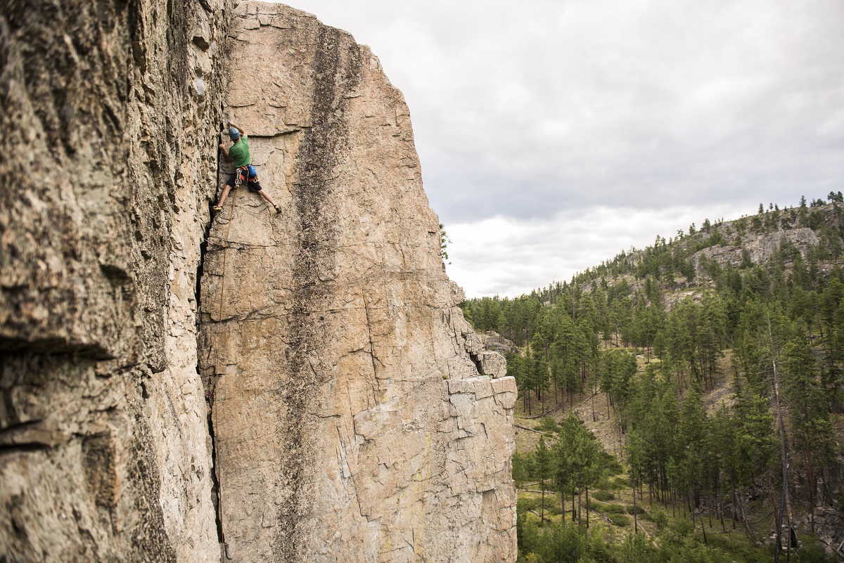 A rock climber works his way up a crack climb on the Diamondback, Skaha Bluffs Provincial Park near Penticton, BC.