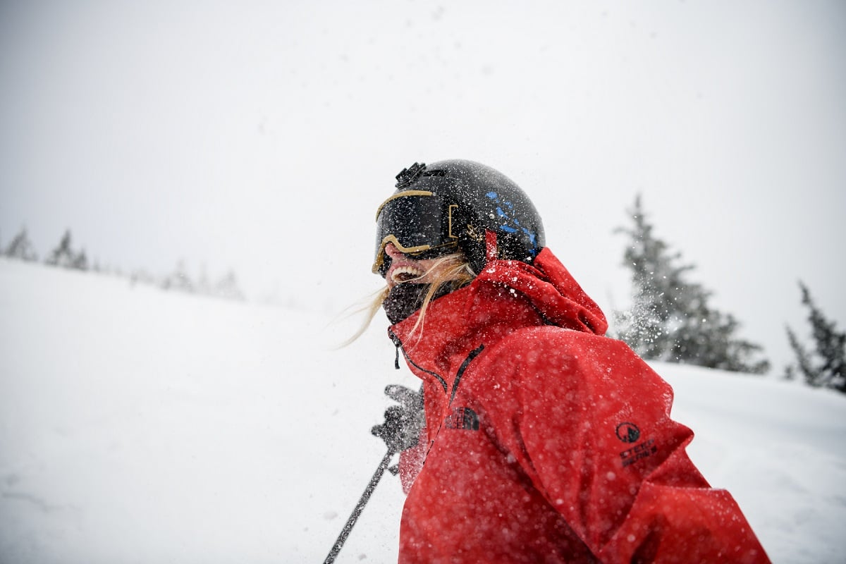 A close up of a skier smiling in a red jacket at Revelstoke Mountain Resort