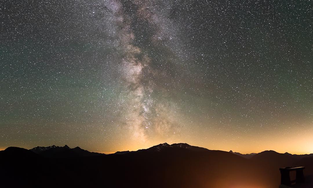 The peaks of Manning Park are visible in the distance with the dying light of sunset barely visible and the Milky Way can be seen in clear night sky