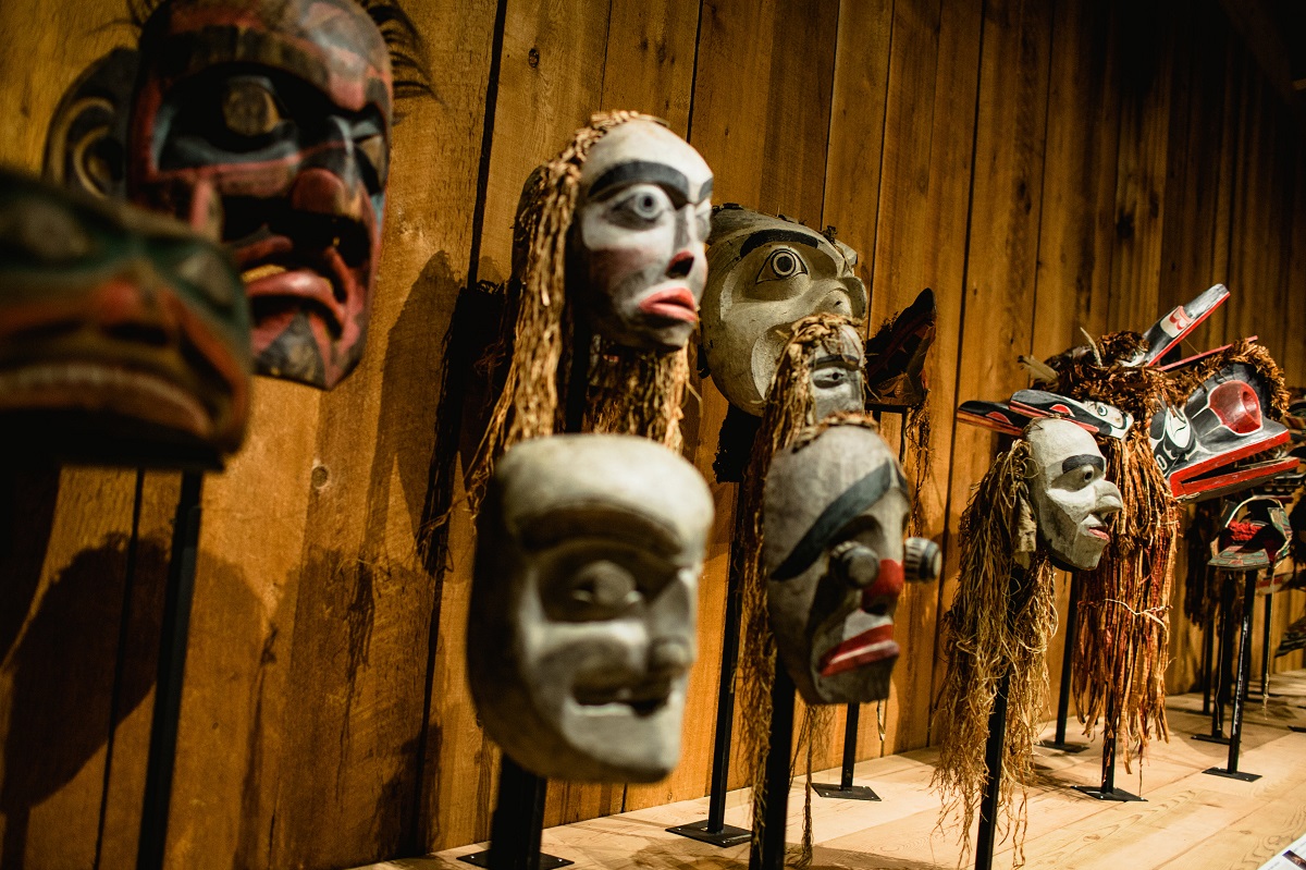 A collection of Indigenous face masks on display inside a museum