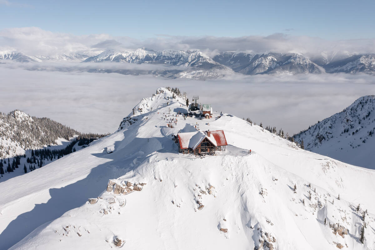 A bird's eye view of Eagle's Eye Restaurant sitting atop a snowy mountain peak.