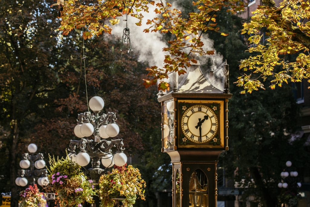 The Steamclock in Gastown during the day. The time reads 1:30 pm and steam comes from the top of the clock. 
