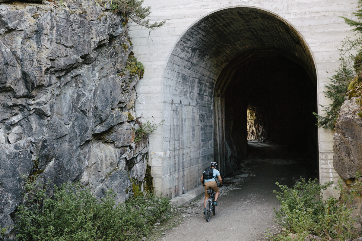 A person heads into a tunnel on their bike in the Myra Canyon section of the Kettle Valley Railway near Kelowna
