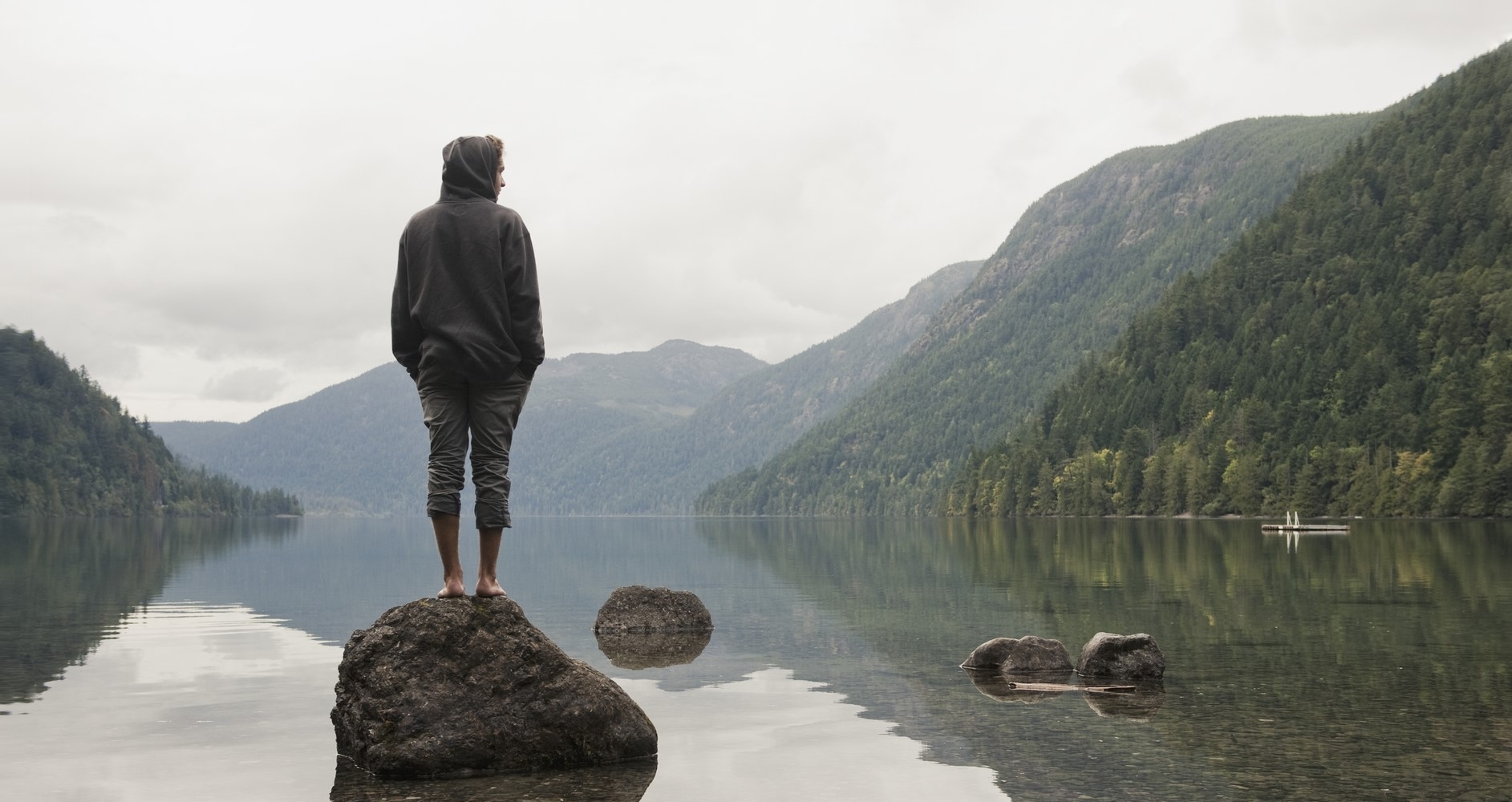 Man standing on a rock at Cameron Lake, Little Qualicum Falls Provincial Park on Vancouver Island.| © Veer Incorporated