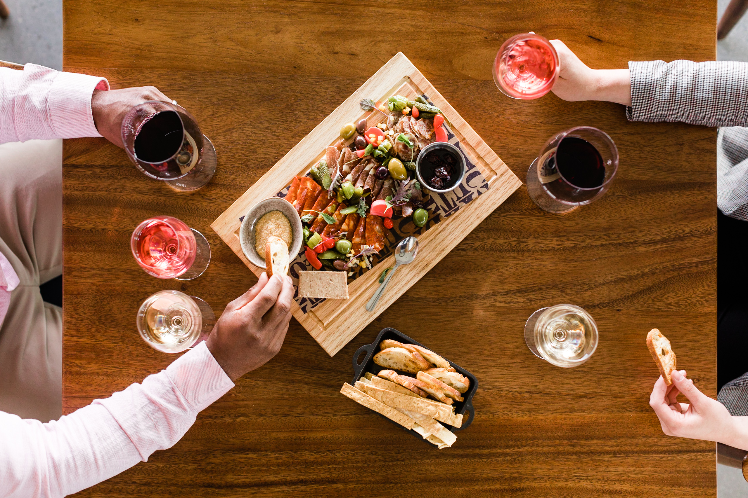 Top down view of a table with drinks and a shared charcuterie board for two diners at Mt. Boucherie Estate Winery in Kelowna