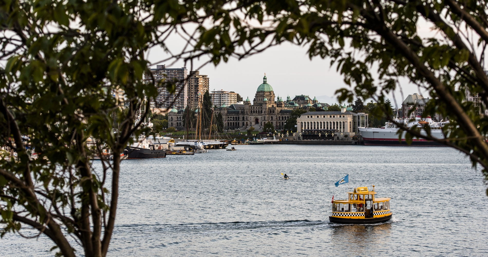 Harbour ferry crossing the Inner Harbour; Parliament Buildings