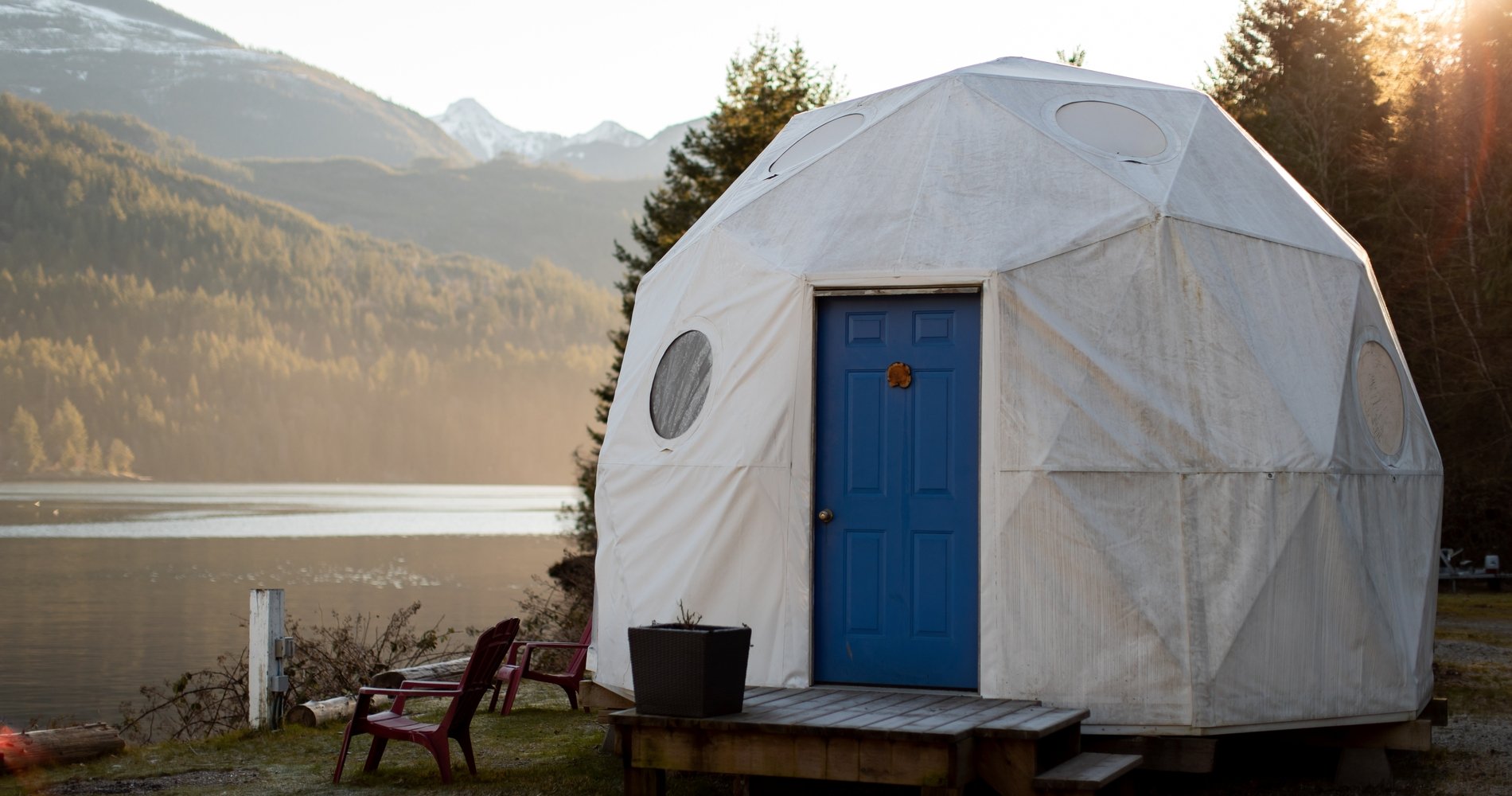 A white dome structure with a blue door on the beach in Tofino from Backeddy Resort.