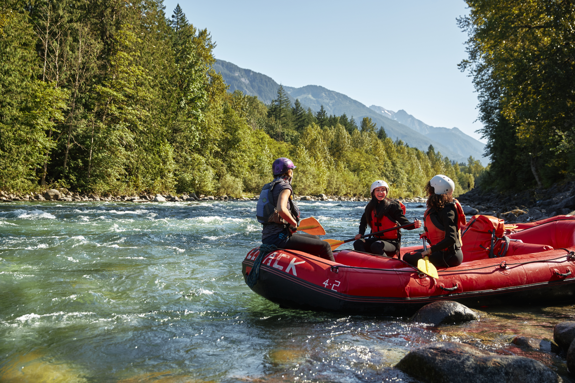 A group of friends river rafting on Vedder River | Hubert Kang