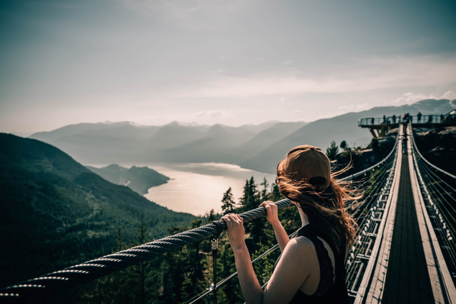 Person viewing Howe Sound from the Sky Pilot Suspension Bridge at the Sea to Sky Gondola in Squamish