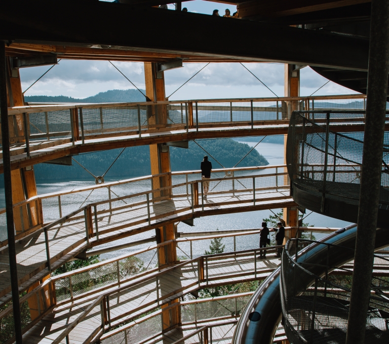 A view from the inside of a massive spiraling ramp that leads to a viewpoint over the ocean and the islands off Vancouver Island