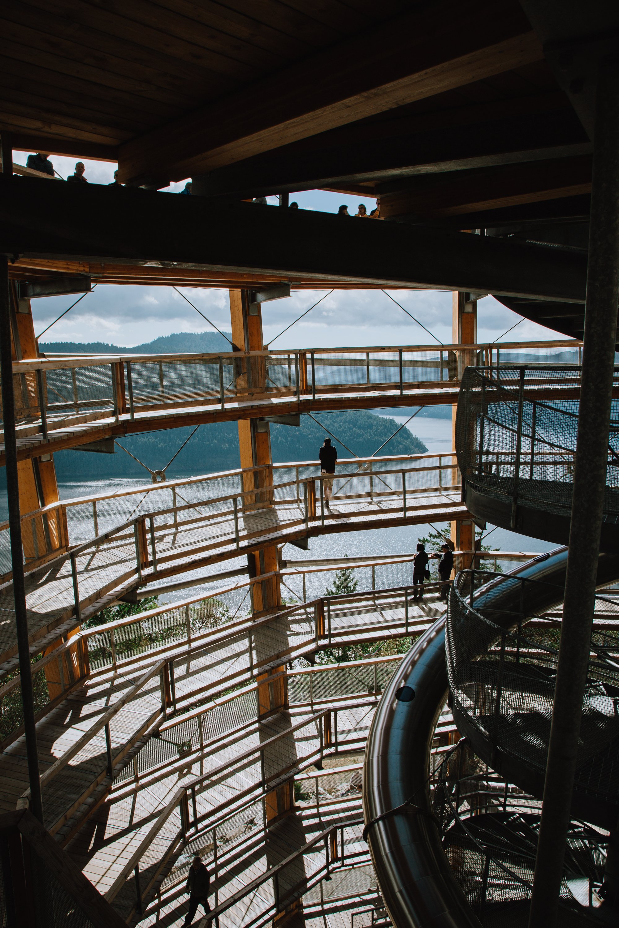 A view from the inside of a massive spiraling ramp that leads to a viewpoint over the ocean and the islands off Vancouver Island