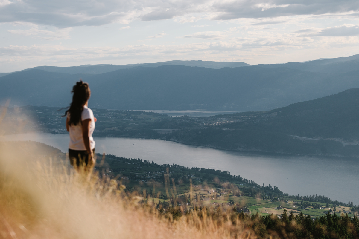 A woman looks out at the lake below the Oyama Lookout.