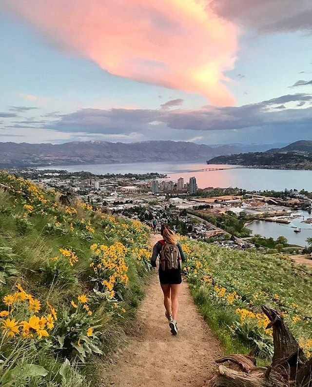 Jogger running along a dirt trail overlooking the lake