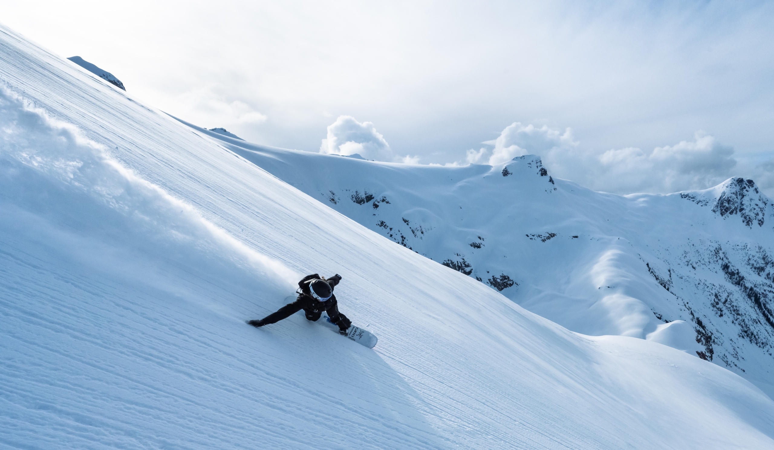 A snowboarder on a mountain in British Columbia