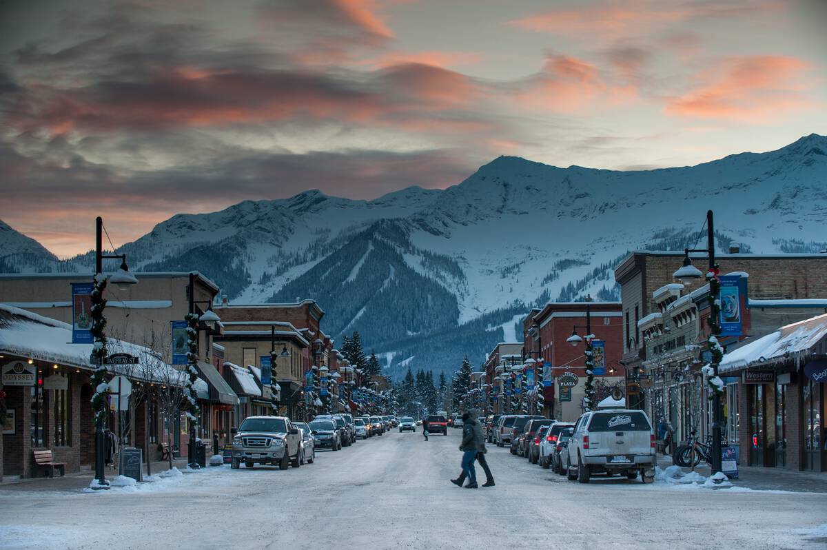Downtown Fernie at dusk with a mountain landscape.