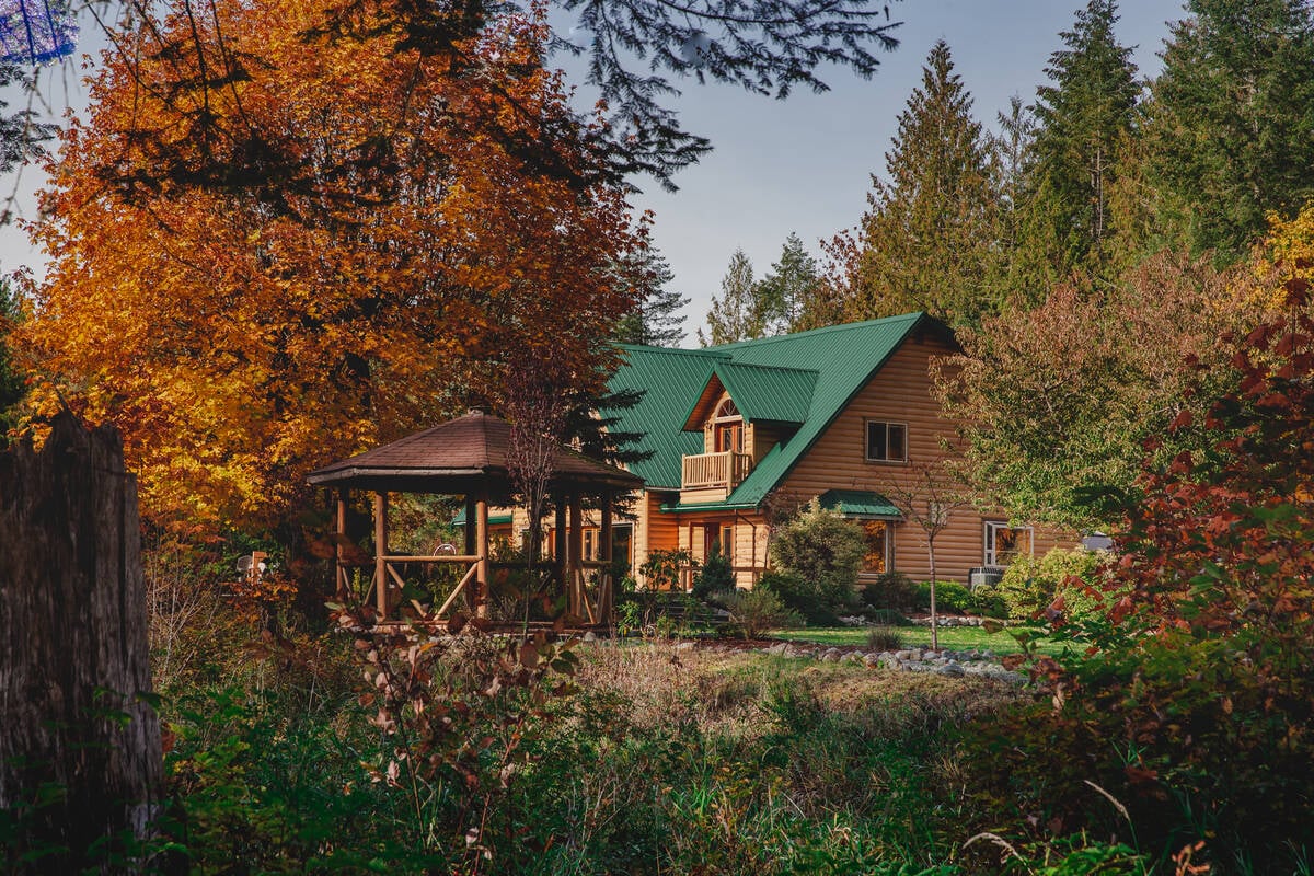Cowichan River Lodge among trees with fall leaves in Lake Cowichan