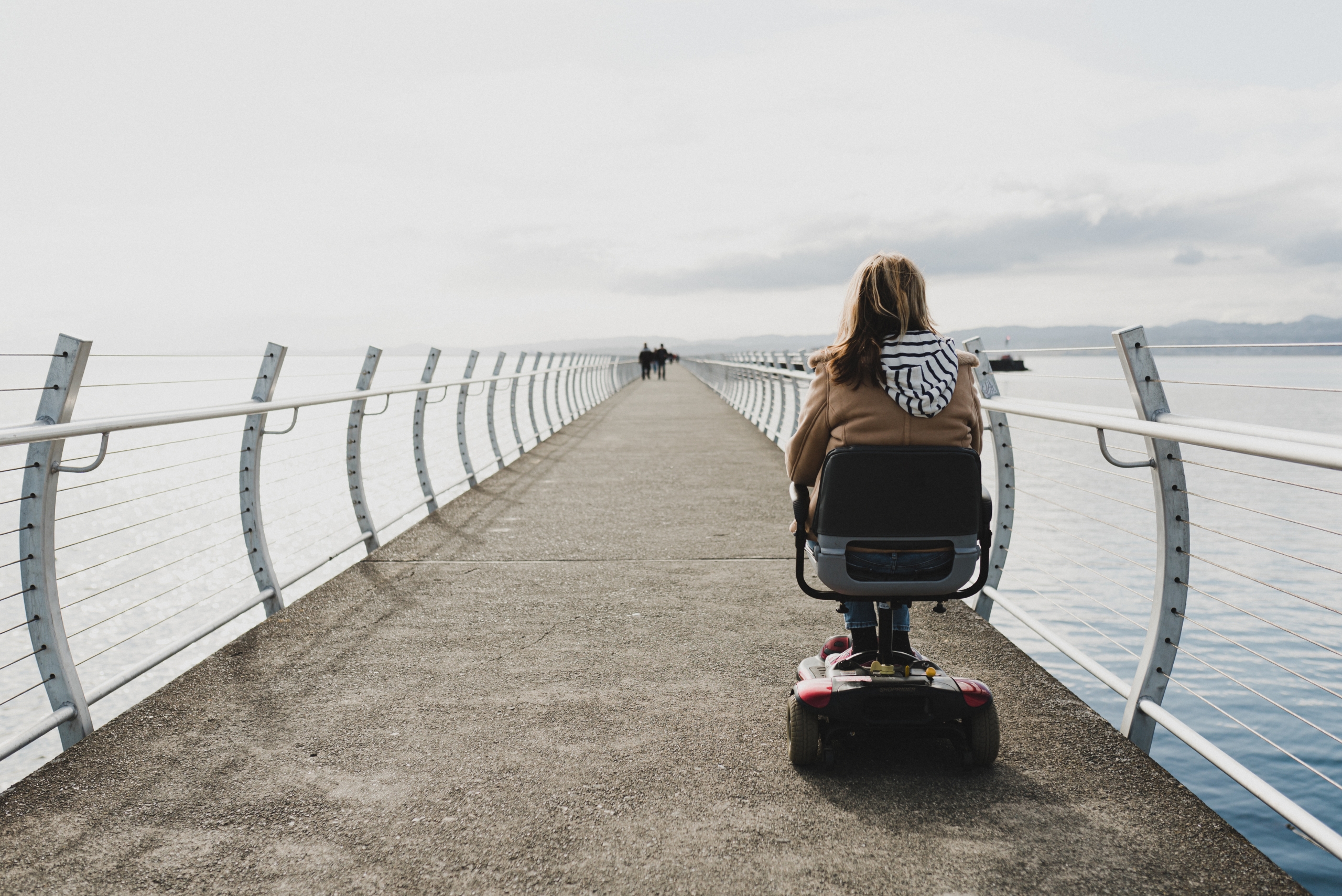 Woman in a wheelchair on the Breakwater in Victoria | Lexa Bergen